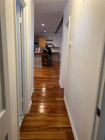 a view of entryway and hall with wooden floor