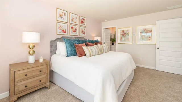 a bedroom with a bed and a night stand