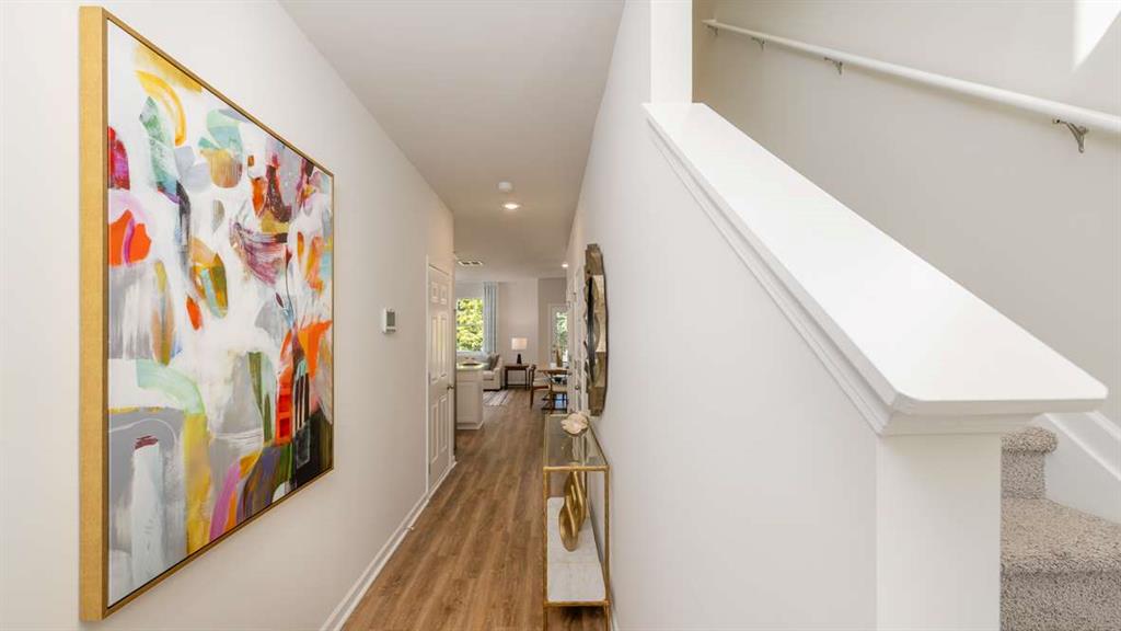 2080 Moss Hill Road Stone Mountain, GA 30083 - Photo 2 of 31 a view of a hallway with wooden floor and staircase
