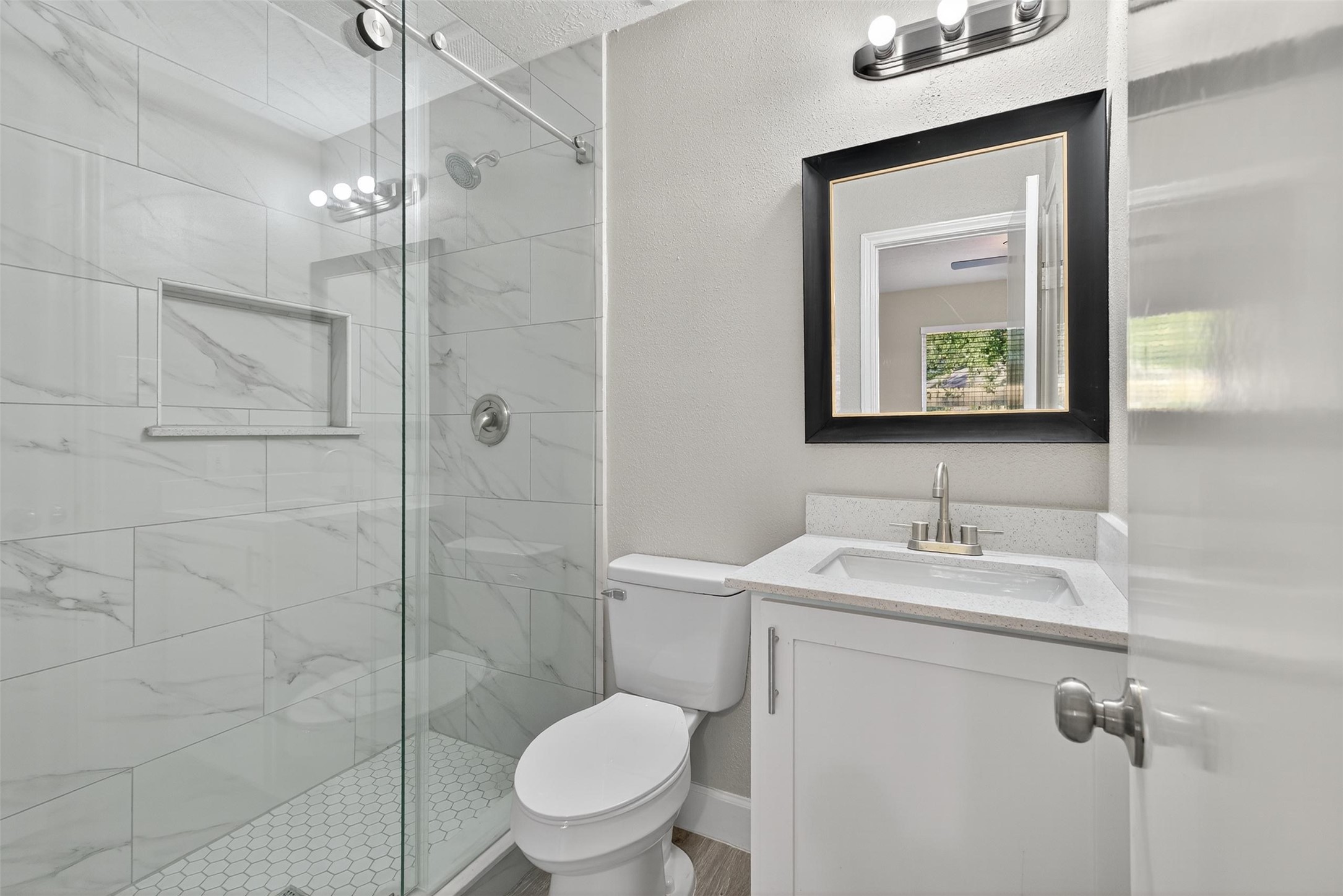 11046 Rainbow Glen Drive Houston, TX 77064 - Photo 15 of 17 a bathroom with a toilet a sink and mirror
