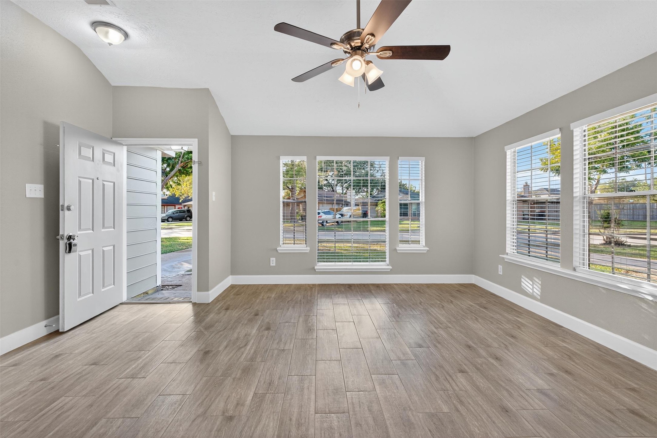 11046 Rainbow Glen Drive Houston, TX 77064 - Photo 4 of 17 a view of an empty room with a window and wooden floor
