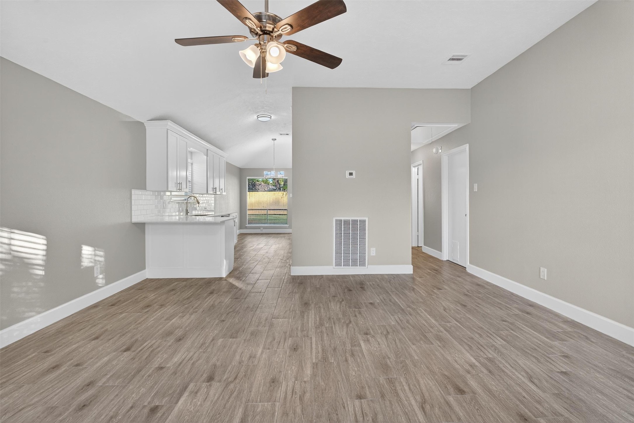 11046 Rainbow Glen Drive Houston, TX 77064 - Photo 5 of 17 a view of an empty room with a window and wooden floor