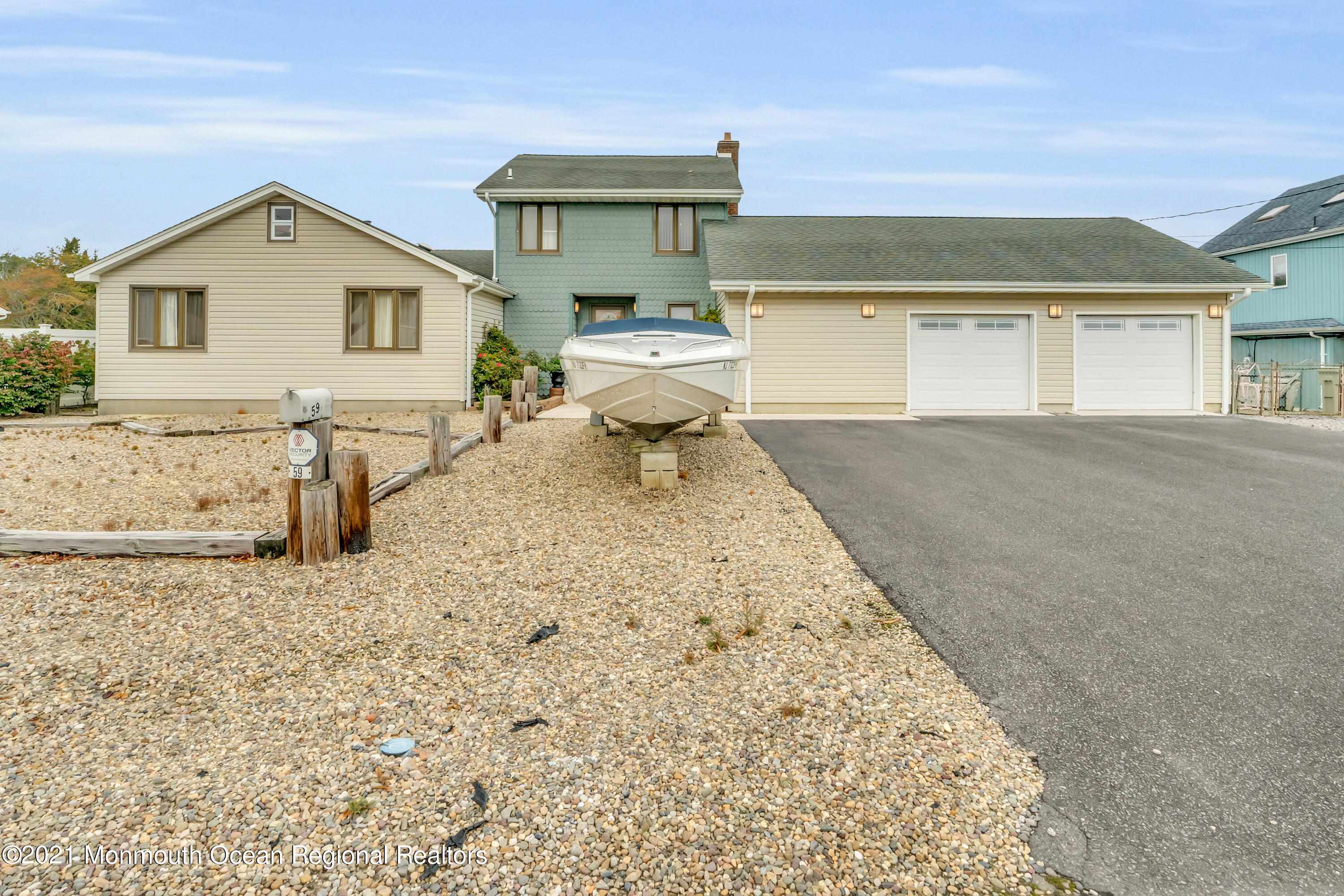 59 Cedar Run Road Bayville, NJ 08721 - Photo 1 of 32 a front view of a house with a yard and garage