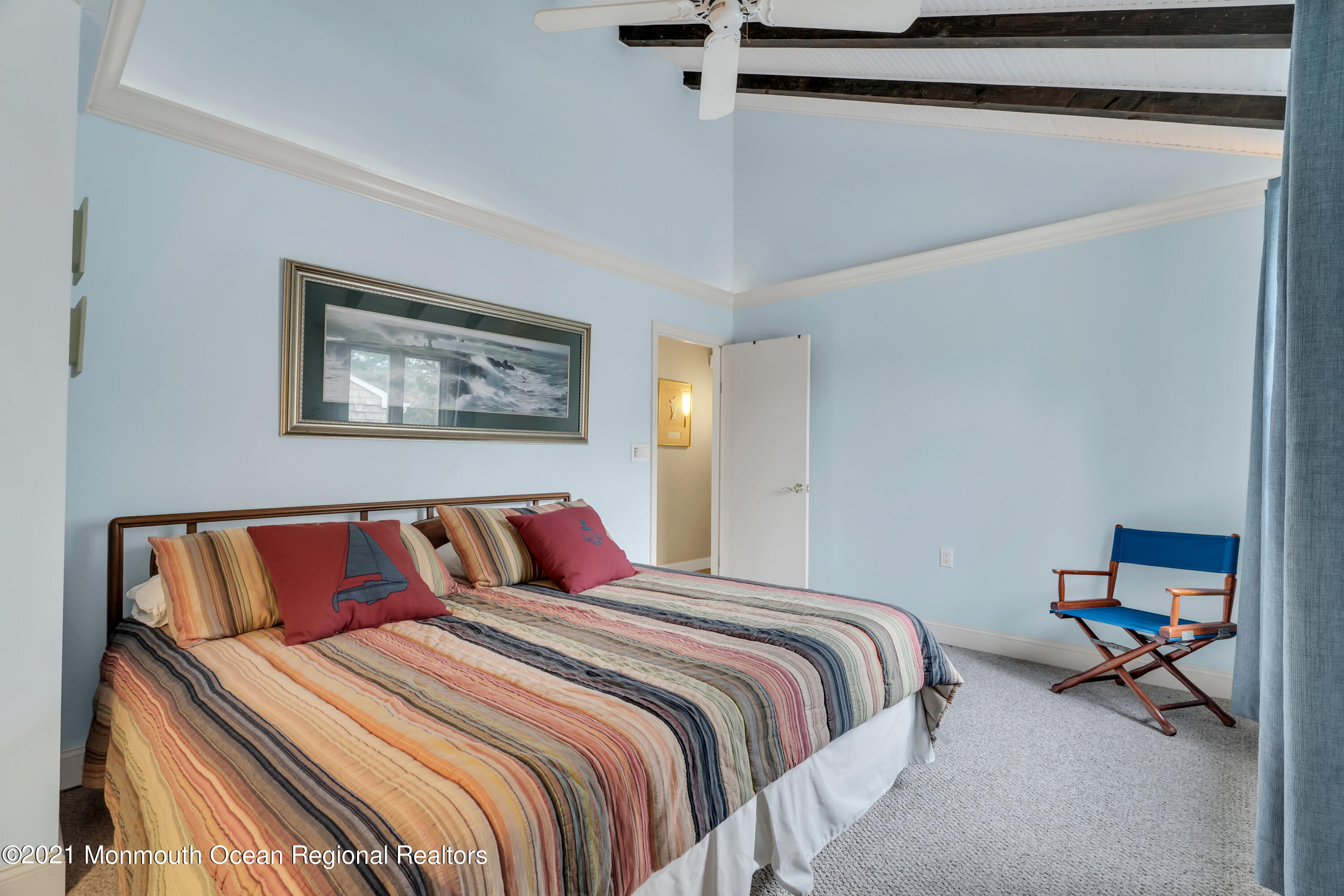59 Cedar Run Road Bayville, NJ 08721 - Photo 19 of 32 a bedroom with a bed and a chandelier