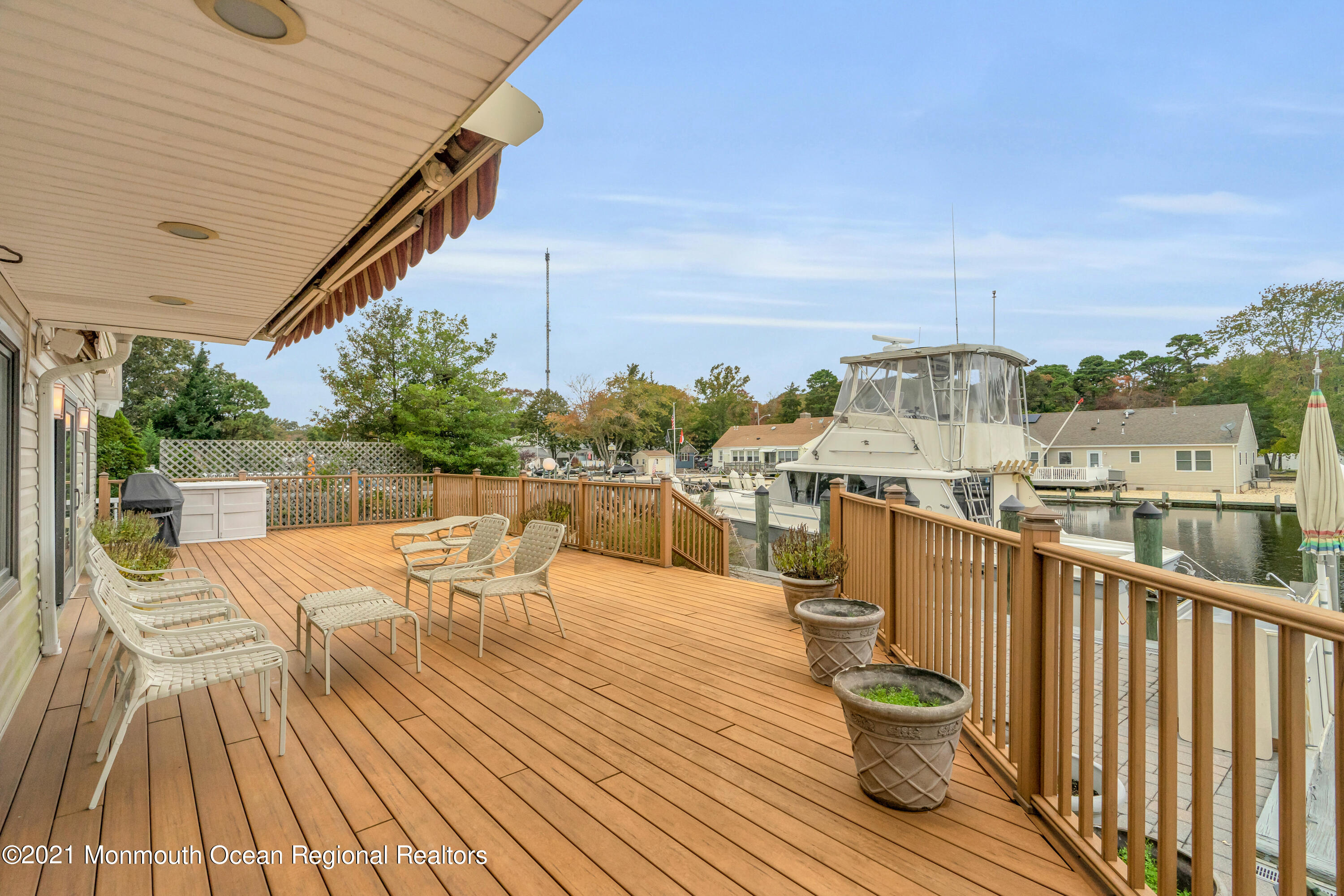 59 Cedar Run Road Bayville, NJ 08721 - Photo 28 of 32 a view of a balcony with chairs and wooden floor