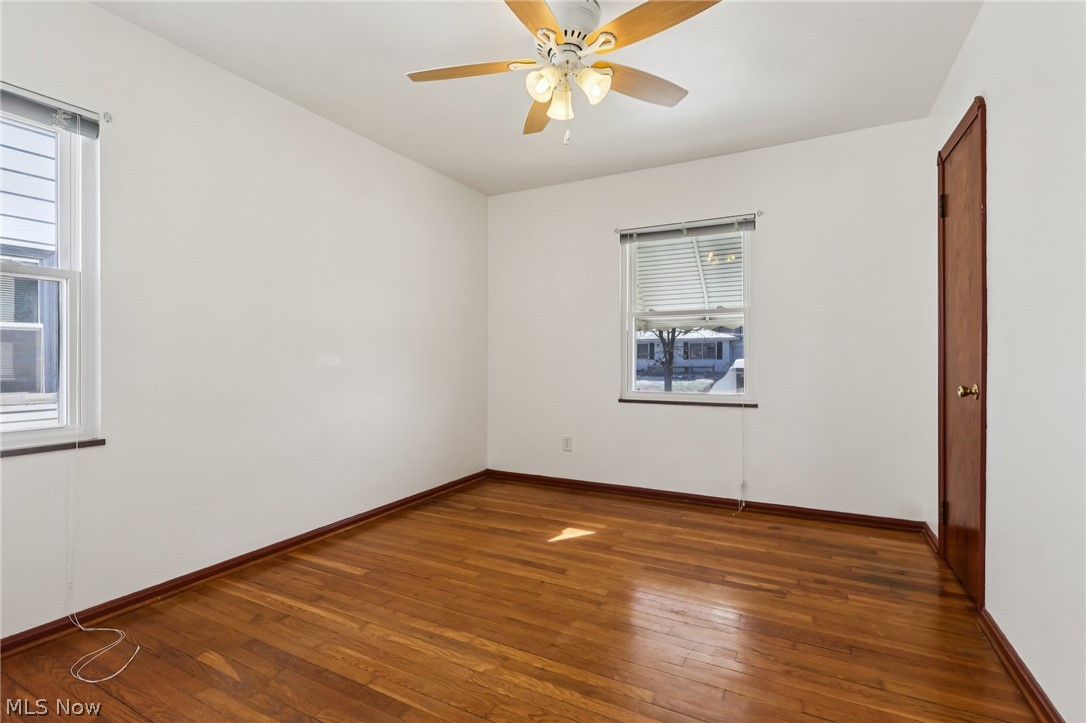4252 Ridgeview Road Cleveland, OH 44144 - Photo 13 of 37 Empty room featuring dark wood-style floors and ceiling fan