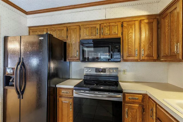 a kitchen with stainless steel appliances granite countertop a stove and a refrigerator