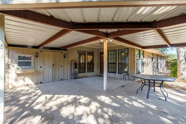 a view of a porch with furniture and a yard
