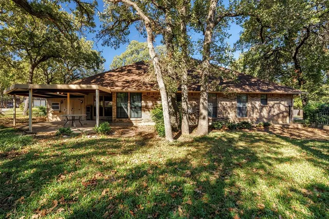 a view of a house with a tree