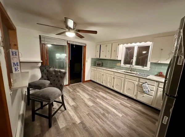 a kitchen with stove a refrigerator and furniture