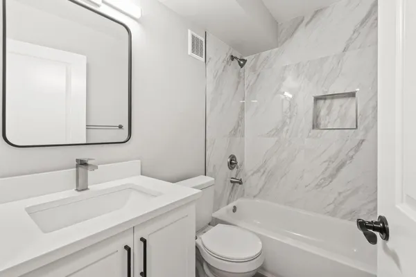a bathroom with a sink toilet and shower