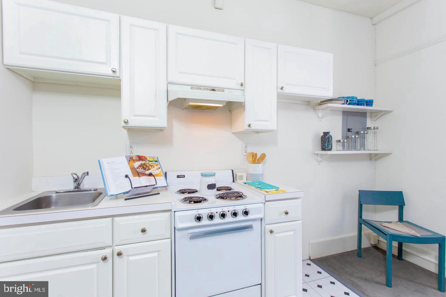 1229 Chestnut Street, Unit 706 Philadelphia, PA 19107 - Photo 11 of 21 a kitchen with white cabinets and appliances