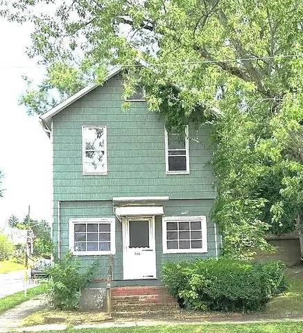 a house that has a tree in front of it