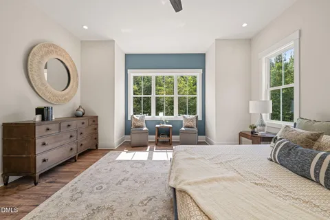 a bedroom with furniture and a large mirror