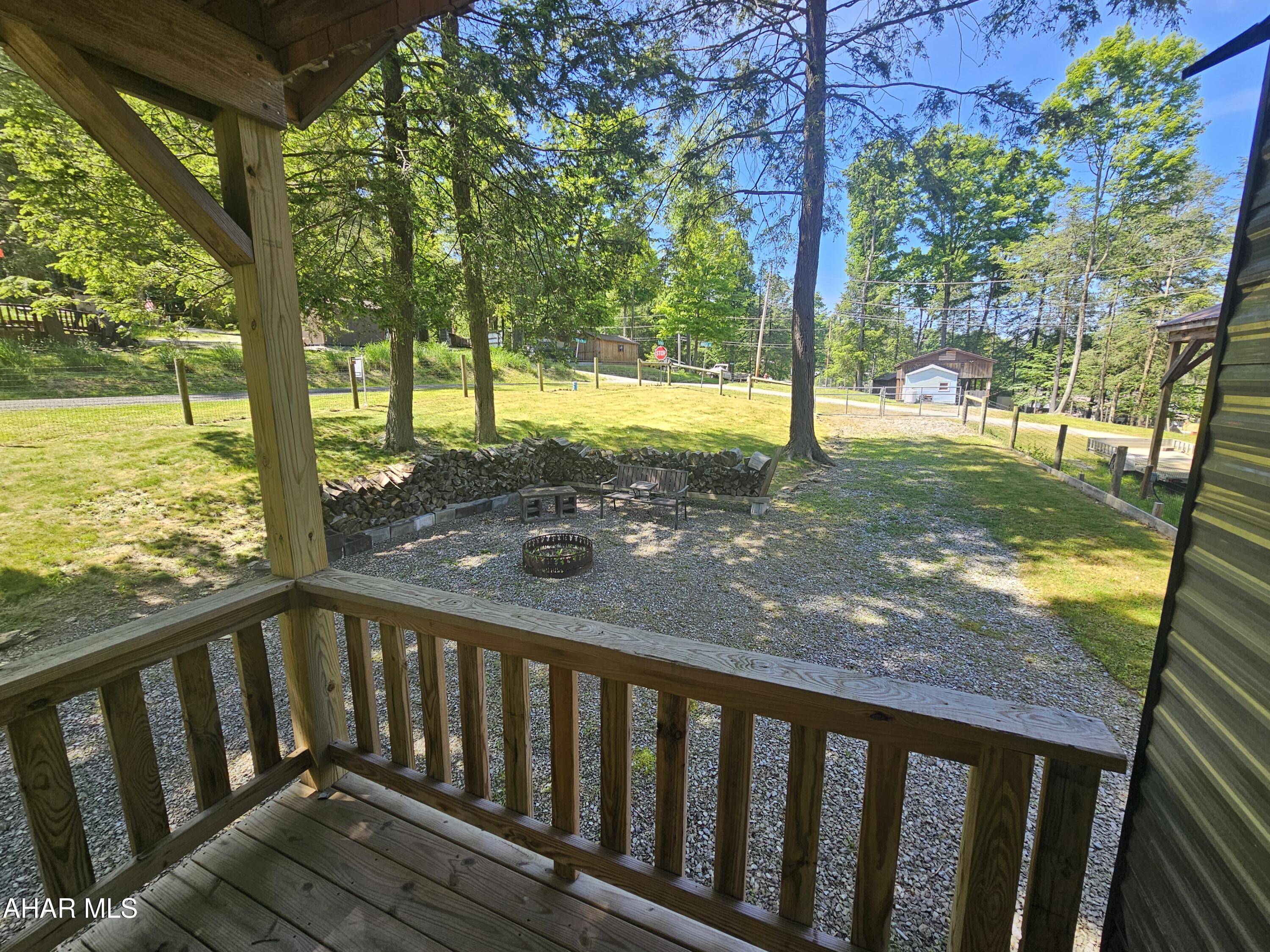 137 Mimosa Circle Flinton, PA 16640 - Photo 8 of 18 a view of a wooden deck next to a yard