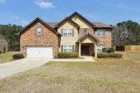 a view of a house with a yard and garage