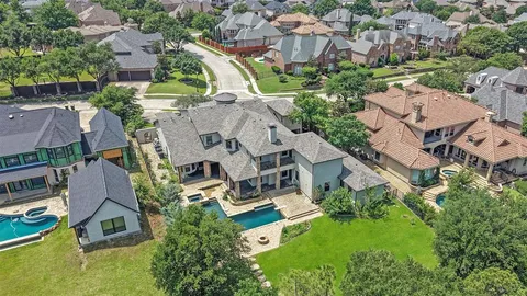 an aerial view of residential house with outdoor space and parking
