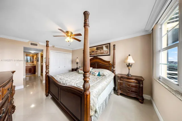 a bedroom with furniture and large windows