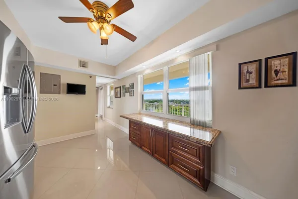a dining room with furniture a chandelier and wooden floor