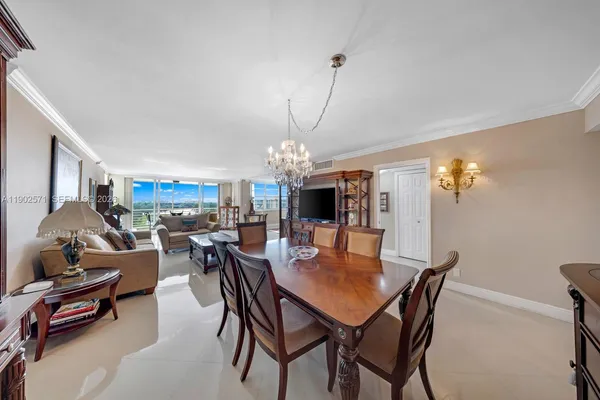 a living room with furniture kitchen view and a window