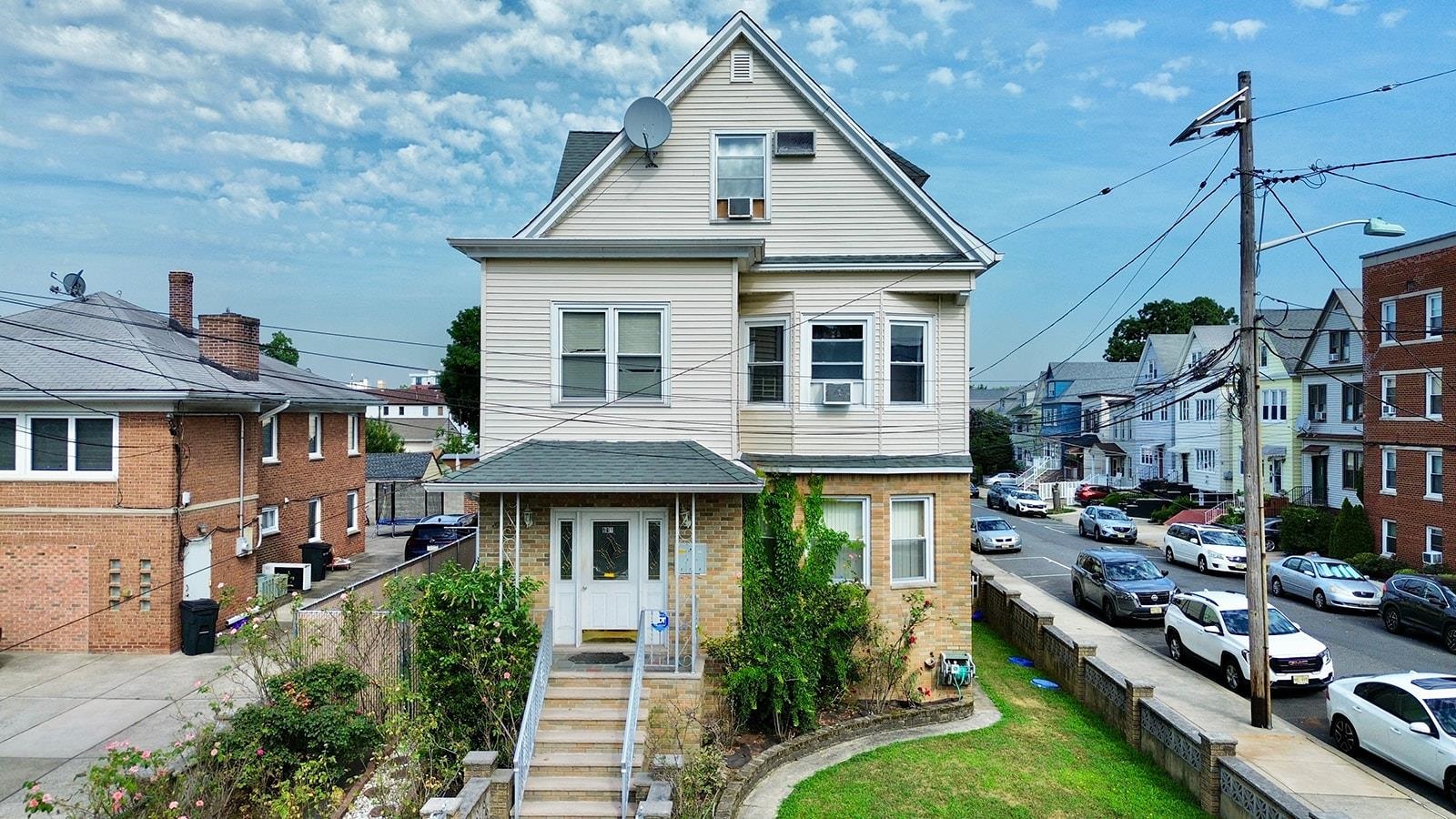 961 Avenue C Bayonne, NJ 07002 - Photo 1 of 21 a front view of a residential apartment building with a yard