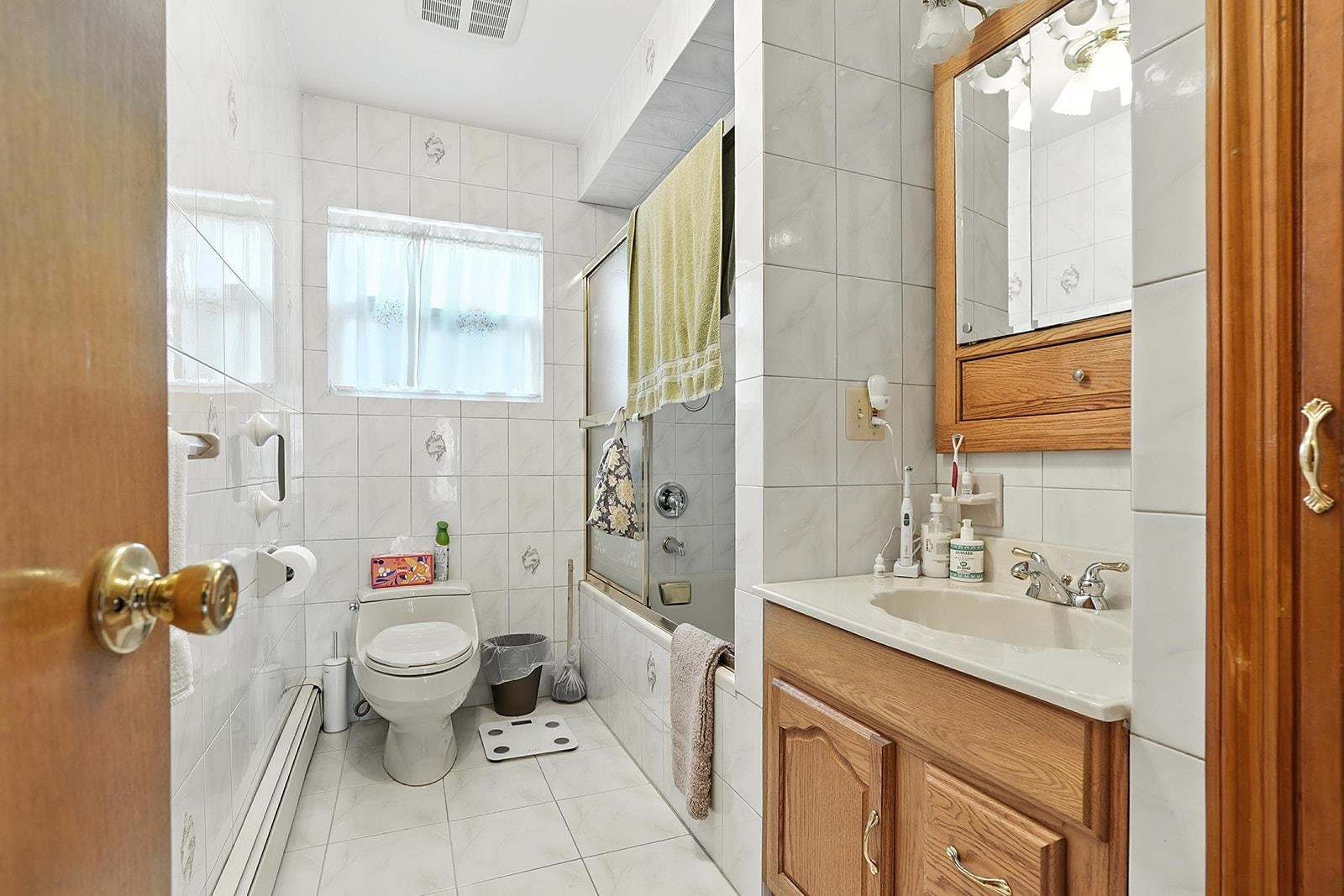 961 Avenue C Bayonne, NJ 07002 - Photo 11 of 21 a bathroom with a sink toilet and shower