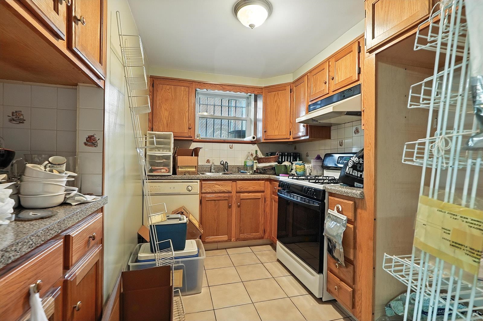 961 Avenue C Bayonne, NJ 07002 - Photo 15 of 21 a kitchen with stainless steel appliances granite countertop a stove a sink and a refrigerator