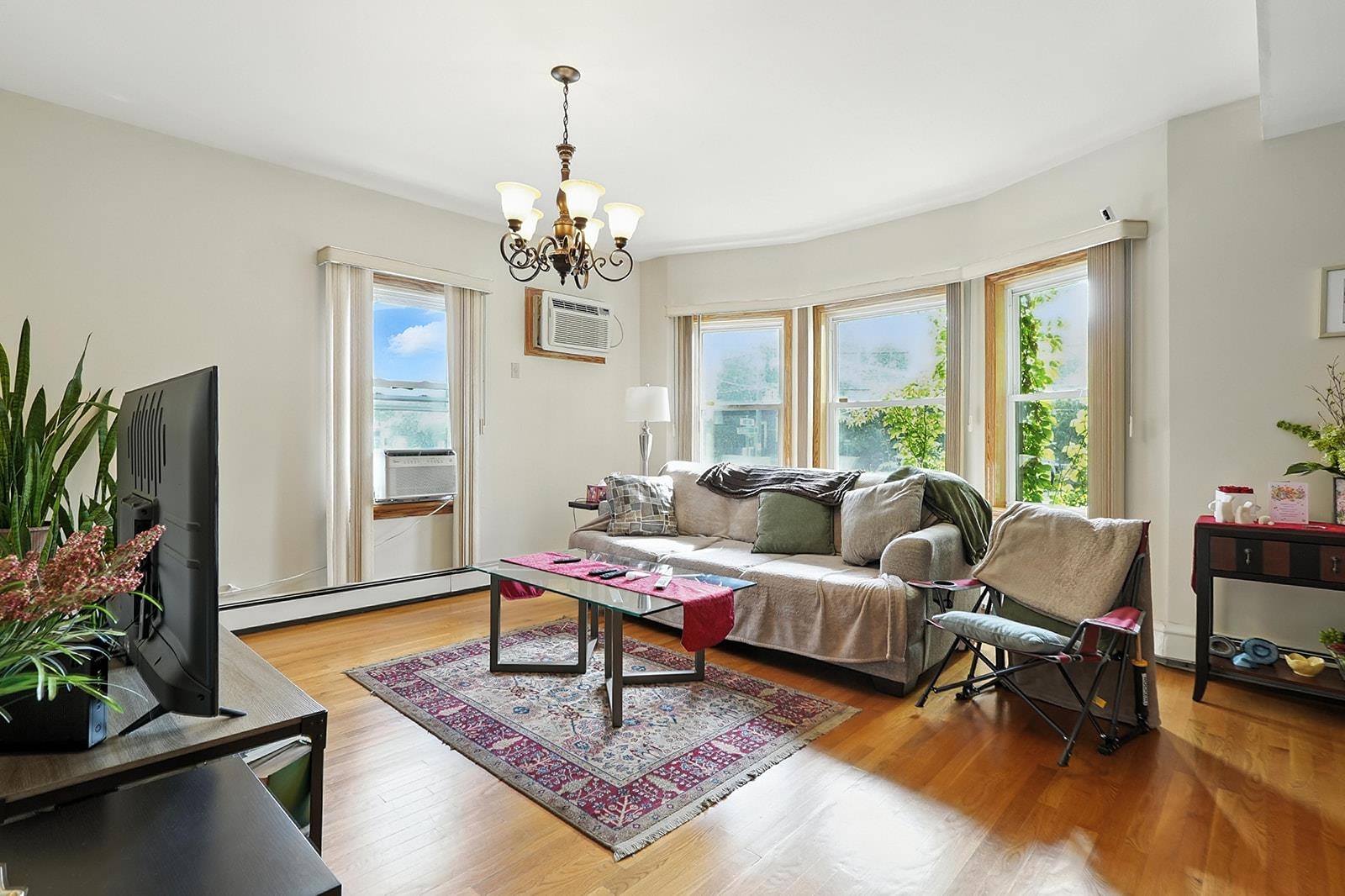 961 Avenue C Bayonne, NJ 07002 - Photo 6 of 21 a living room with furniture and a flat screen tv