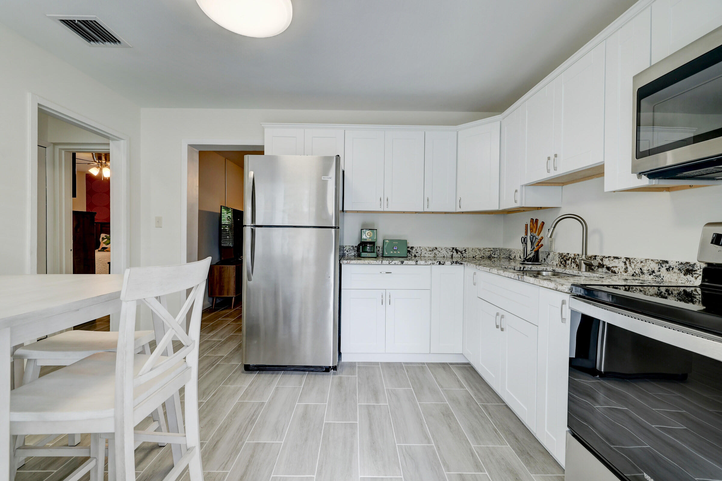 125 South 10th Street Fort Pierce, FL 34950 - Photo 12 of 30 a kitchen with stainless steel appliances granite countertop a refrigerator sink and stove