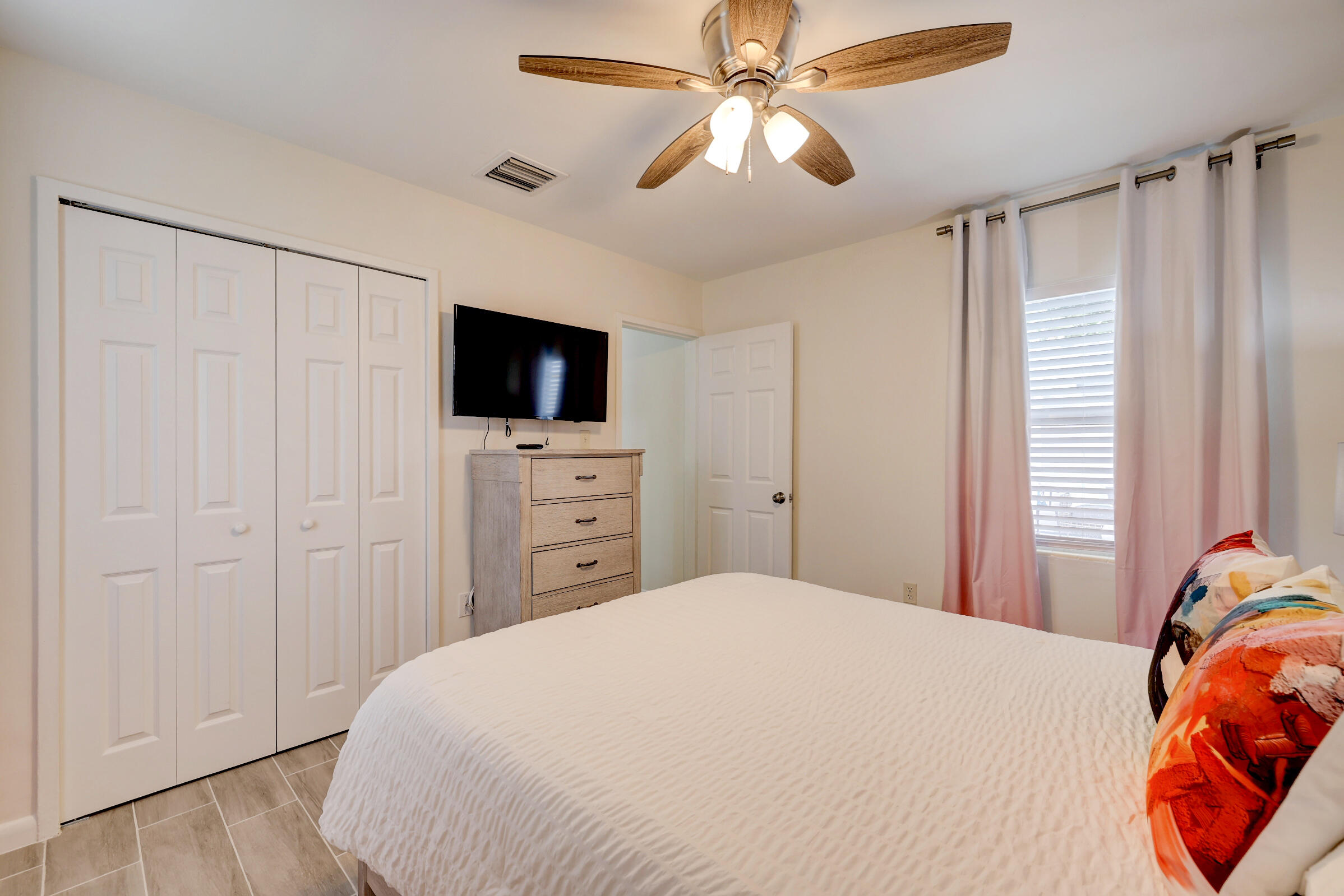 125 South 10th Street Fort Pierce, FL 34950 - Photo 15 of 30 a bedroom with a bed and a flat screen tv