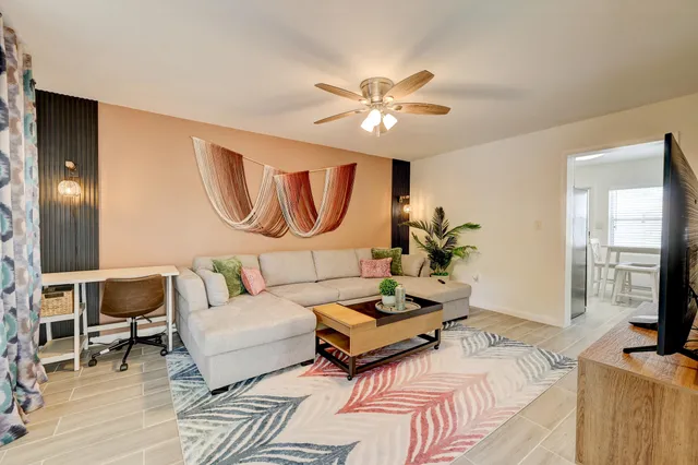 a living room with furniture fireplace and a flat screen tv