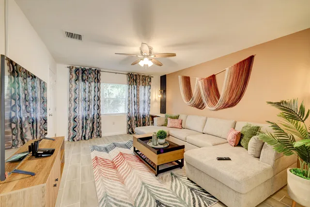 a living room with furniture and a chandelier