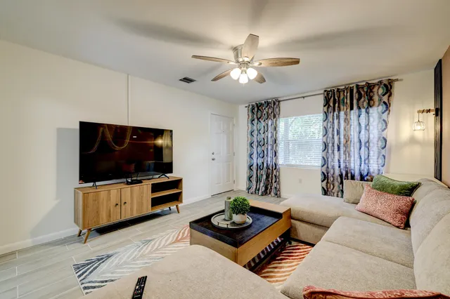 a living room with furniture and a flat screen tv