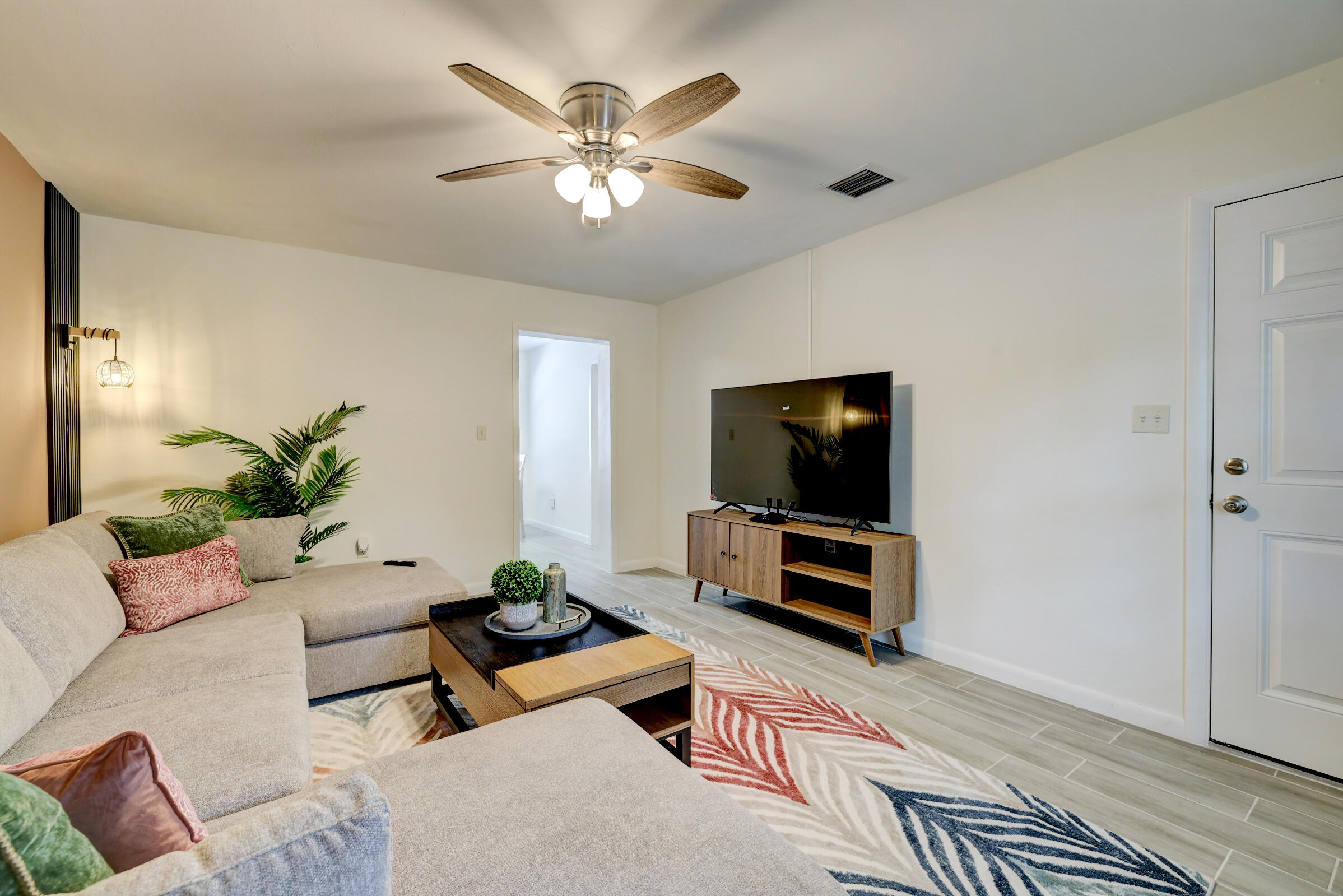 125 South 10th Street Fort Pierce, FL 34950 - Photo 8 of 30 a living room with furniture and a flat screen tv