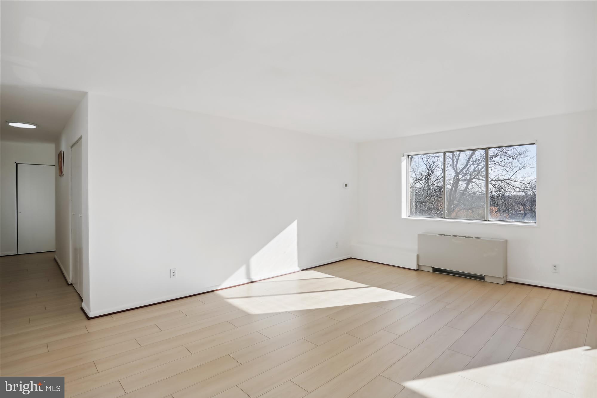 614 Sligo Avenue, Unit 508 Silver Spring, MD 20910 - Photo 13 of 31 an empty room with wooden floor and windows