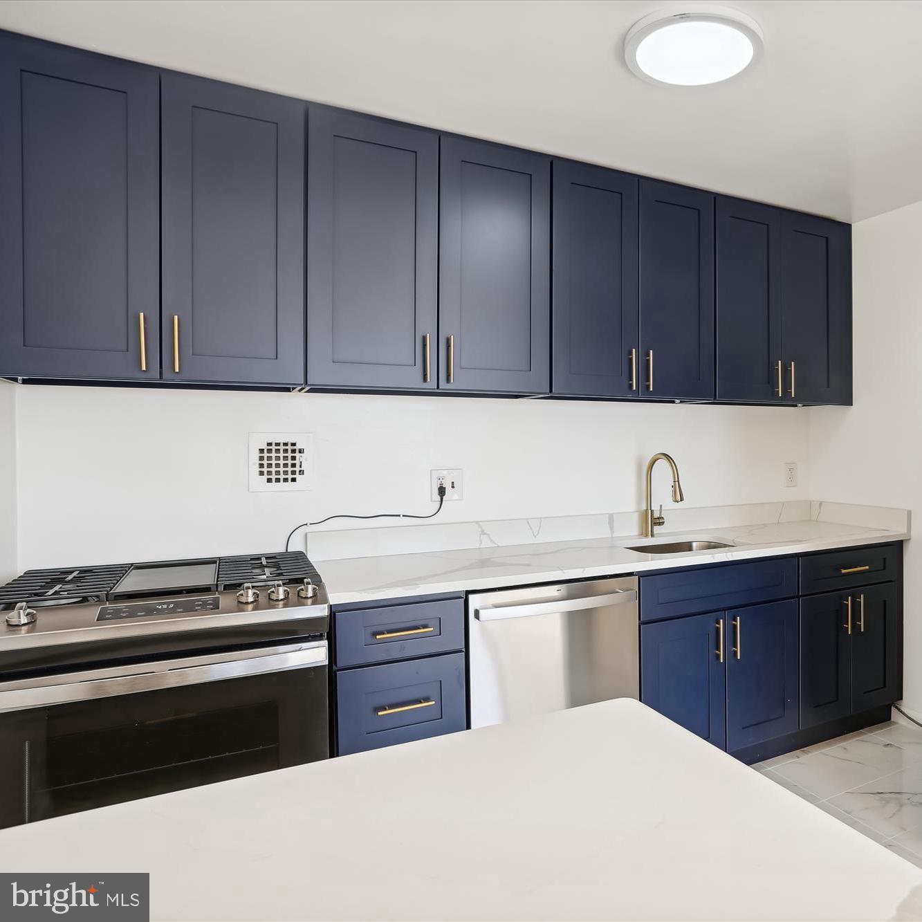 614 Sligo Avenue, Unit 508 Silver Spring, MD 20910 - Photo 5 of 31 a kitchen with a cabinets and white appliances