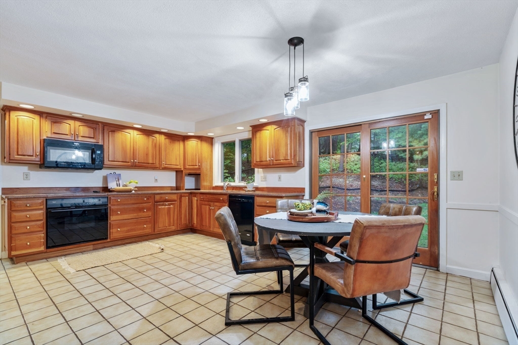 369 Border Road Concord, MA 01742 - Photo 12 of 34 a kitchen with stainless steel appliances kitchen island granite countertop a sink and cabinets