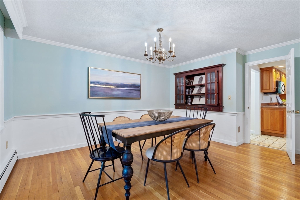 369 Border Road Concord, MA 01742 - Photo 15 of 34 a view of a dining room with furniture wooden floor and chandelier