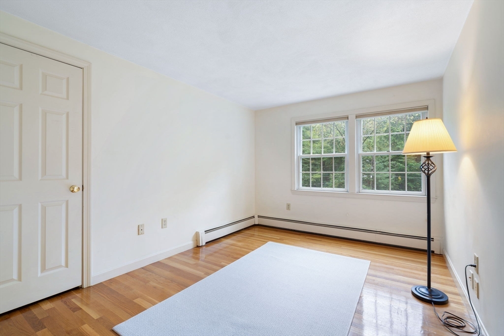 369 Border Road Concord, MA 01742 - Photo 26 of 34 a view of an empty room with a window and wooden floor