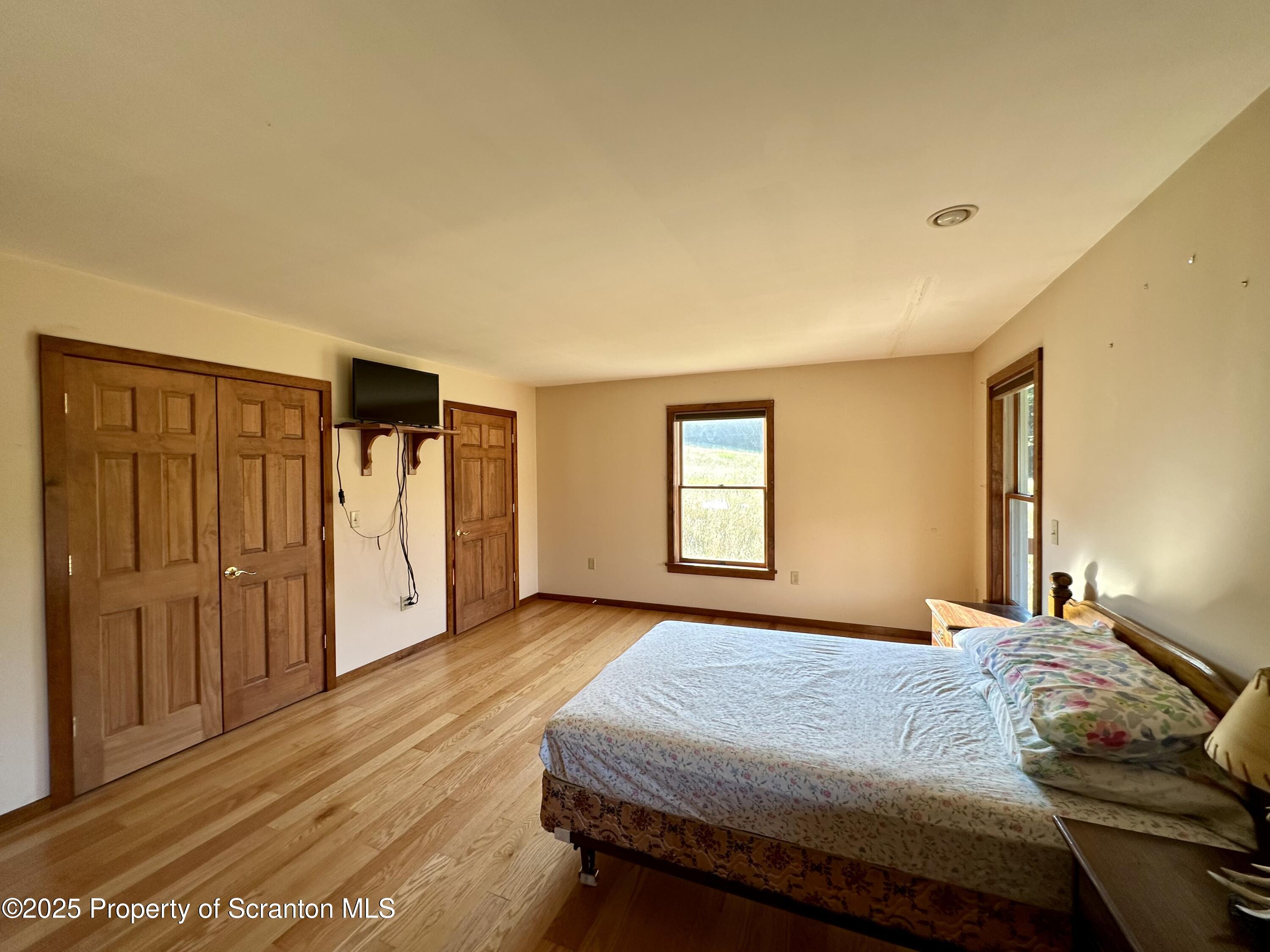 5290 Irish Hill Road Montrose, PA 18801 - Photo 35 of 67 a bedroom with a bed and wooden floor