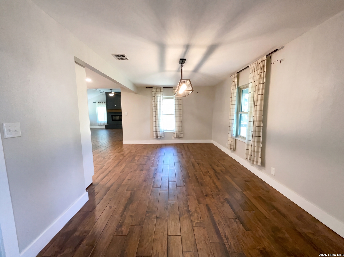 15422 Geronimo Loop San Antonio, TX 78254 - Photo 10 of 21 wooden floor in an empty room with a window
