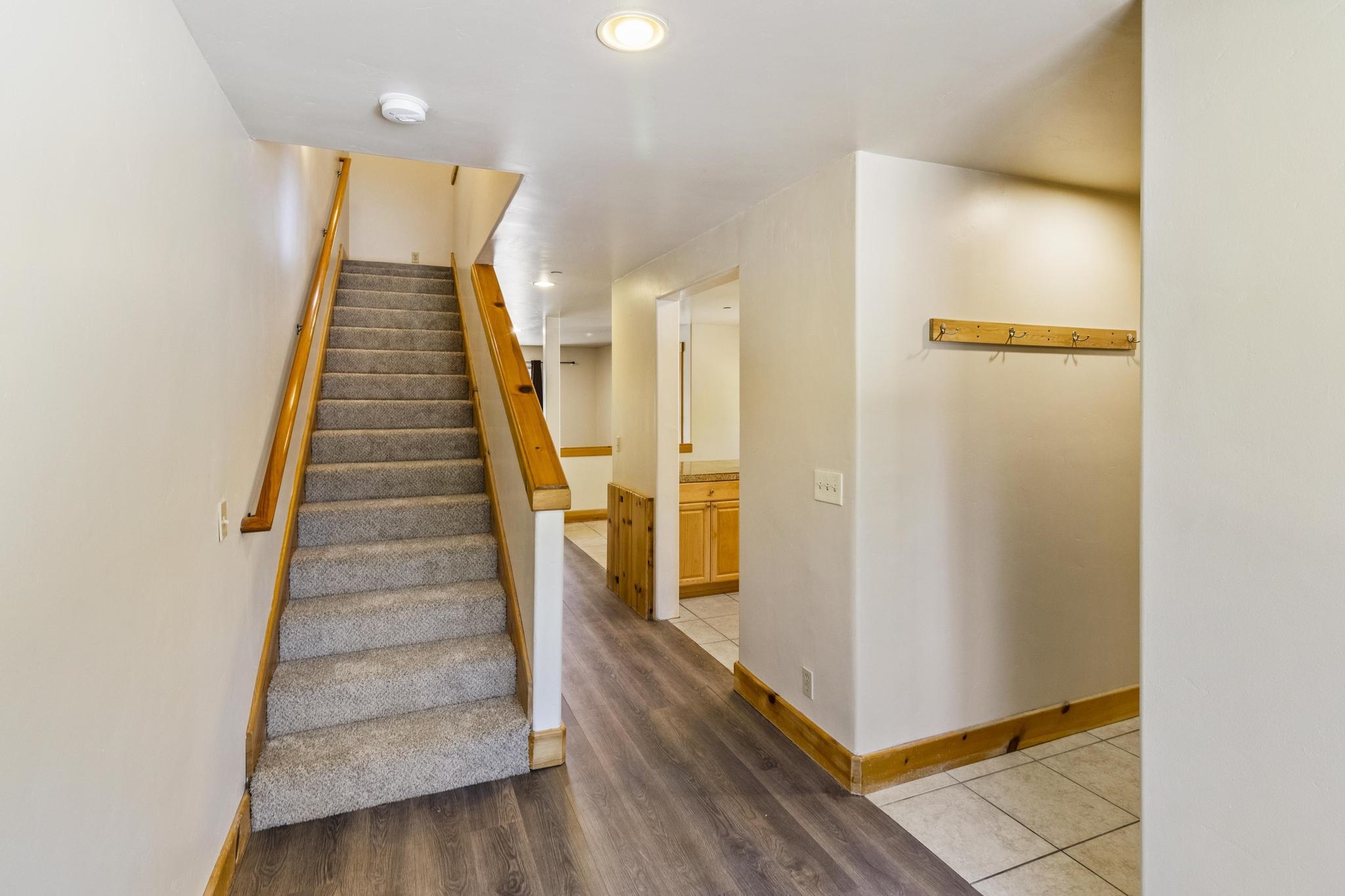 6980 Toyon Road Tahoe Vista, CA 96148 - Photo 11 of 20 a view of a hallway with staircase and wooden floor