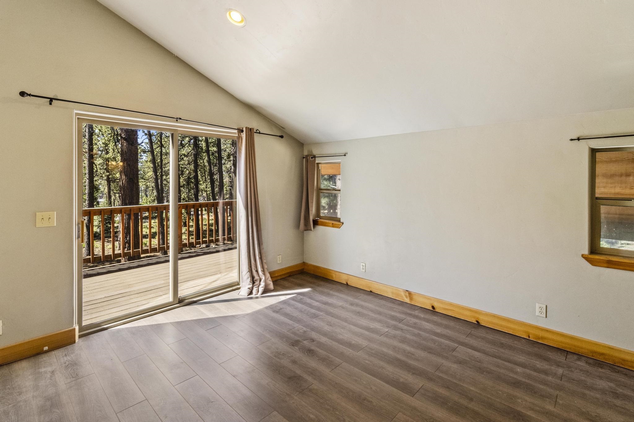 6980 Toyon Road Tahoe Vista, CA 96148 - Photo 12 of 20 an empty room with wooden floor and windows