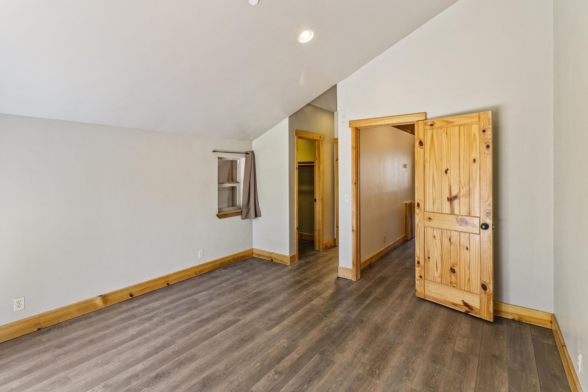 6980 Toyon Road Tahoe Vista, CA 96148 - Photo 13 of 20 a view of an empty room with wooden floor and a window
