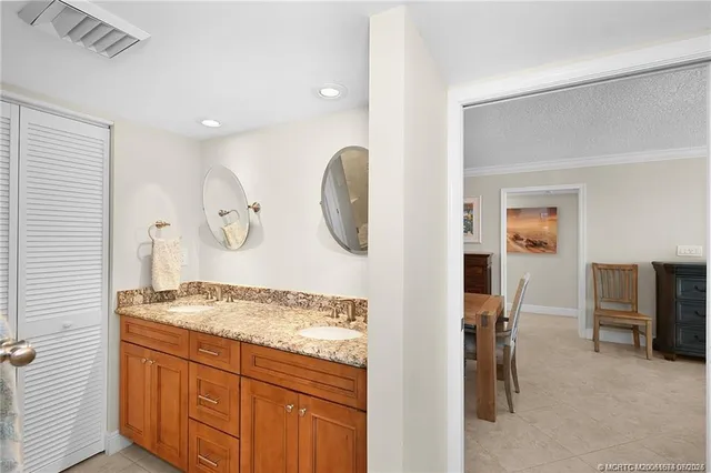 a bathroom with a granite countertop sink mirror and vanity