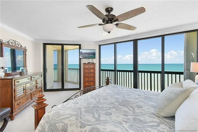 a spacious bedroom with a large bed and a large window