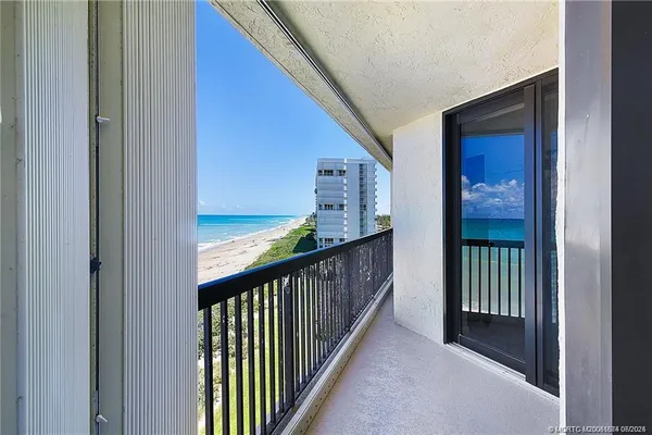 a view of a balcony with wooden floor