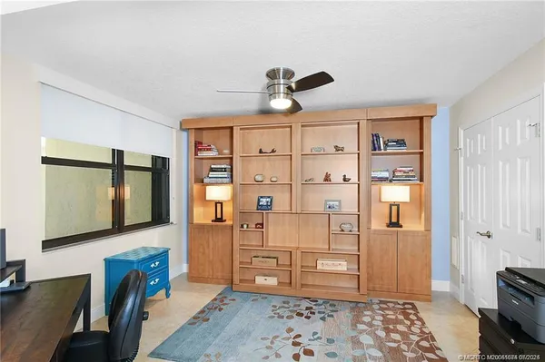 a view of a bedroom with furniture and window