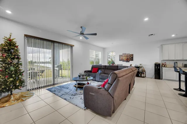 a living room with furniture and a floor to ceiling window