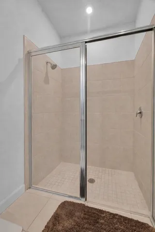 a bathroom with a glass shower door
